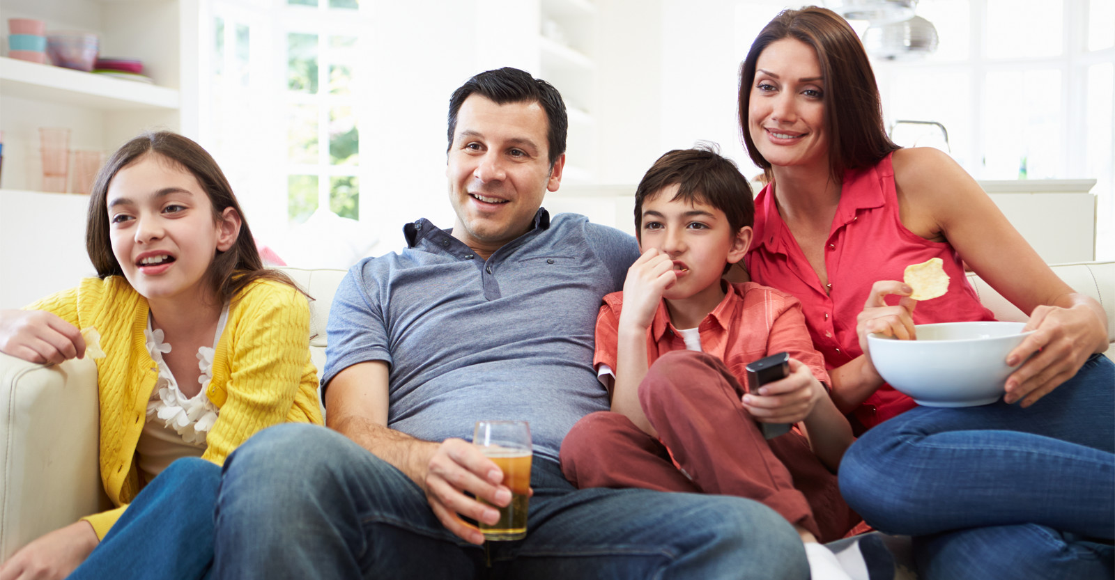 Family on couch watching TV