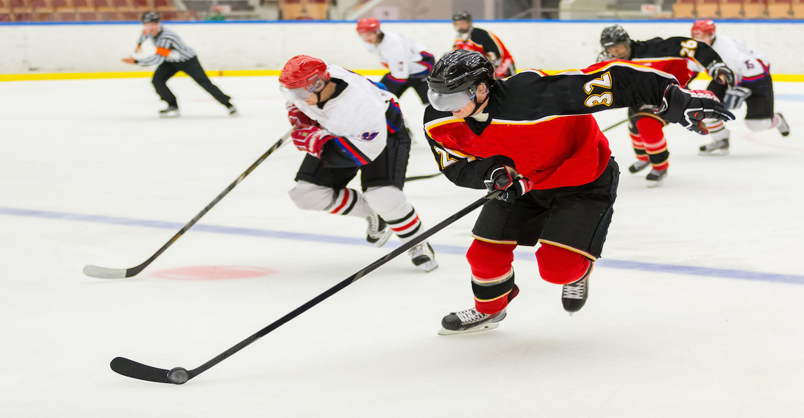 Hockey players racing to the puck