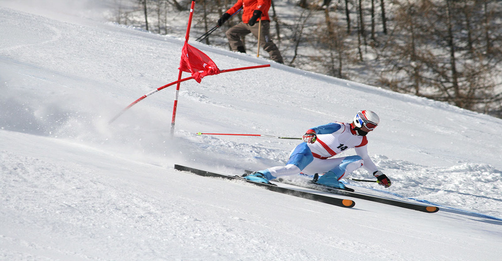 Downhill skier going through the gates