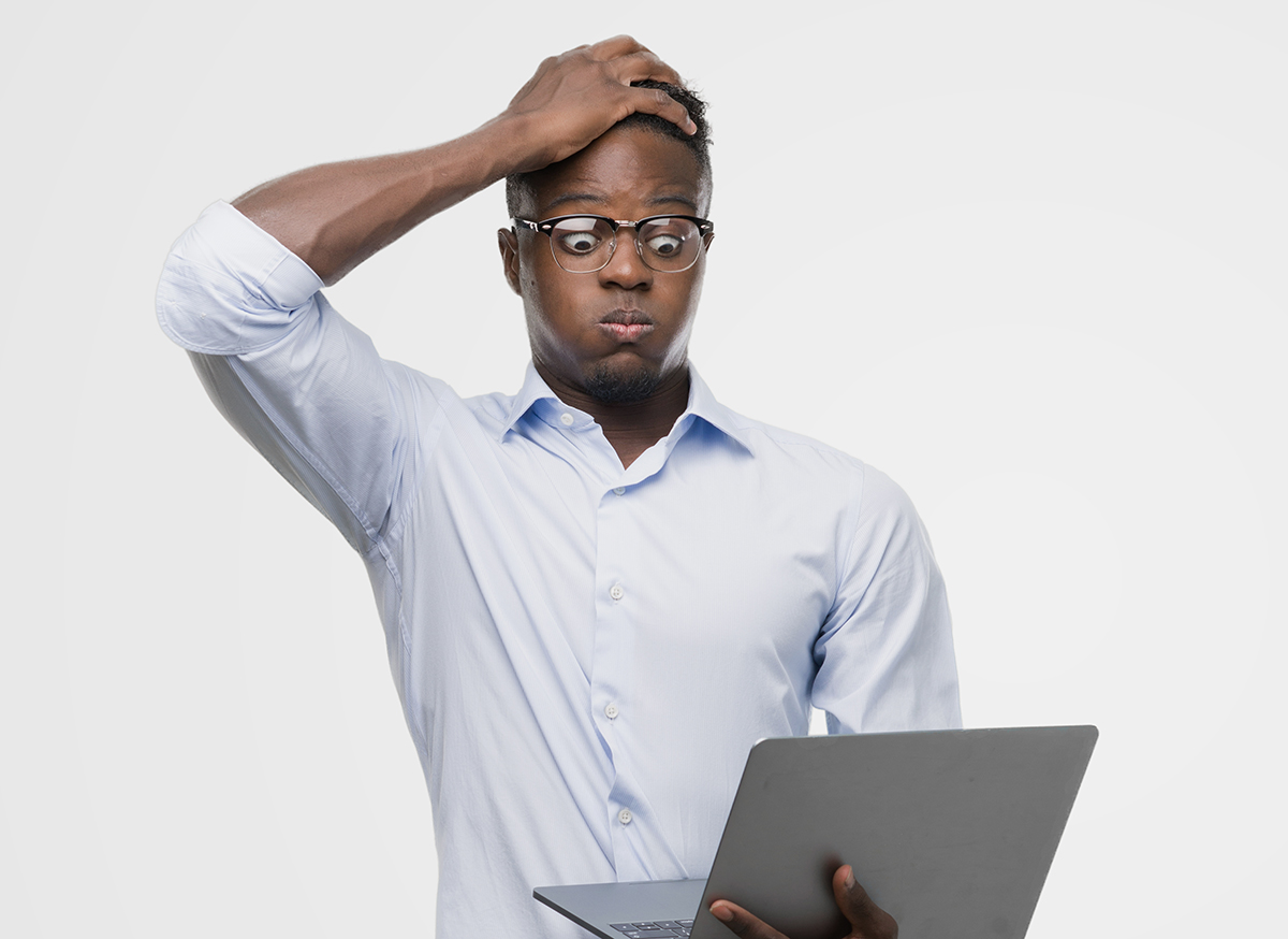 man looking very frustrated at his computer paying cable bill